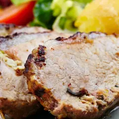 Kawałki pieczonej wieprzowiny, ziemniaki i sałatka. Częste jedzenie tłustej wieprzowiny może wpływać na trójglicerydy i wątrobę.