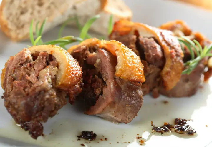 Faszerowana szyja gęsia, tradycyjny przepis babci na zapomniany rarytas z drobiu. Aromatyczne mięso z chrupiącą skórką, podane z pieczywem i rozmarynem.
